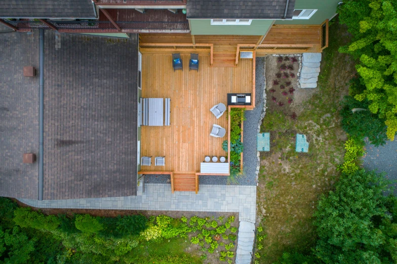 a small home with wooden decking in the backyard