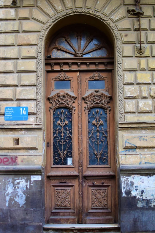 an old door with an intricate design is shown in front of a stone building