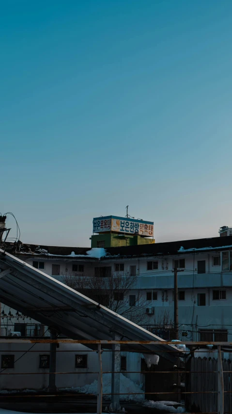 some buildings and snow are visible on the roof