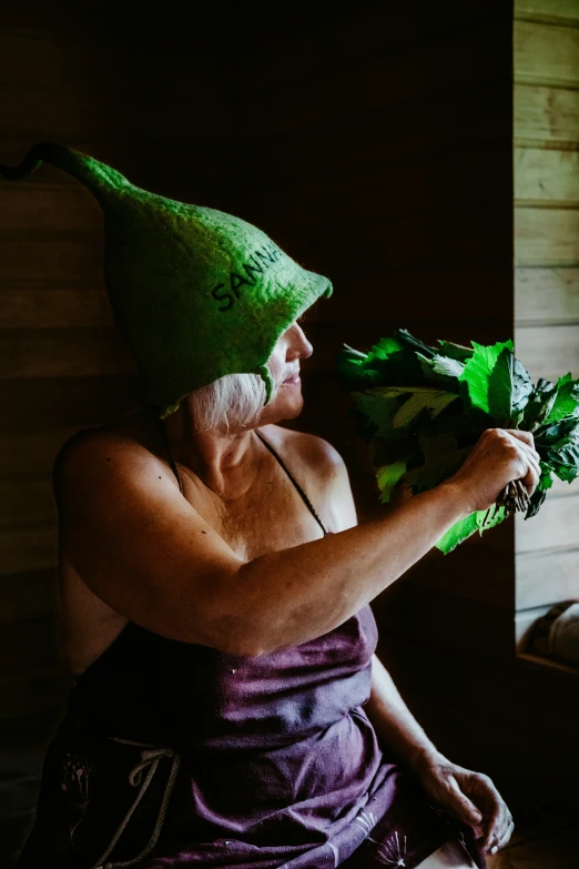 the woman is wearing a towel and holding vegetables