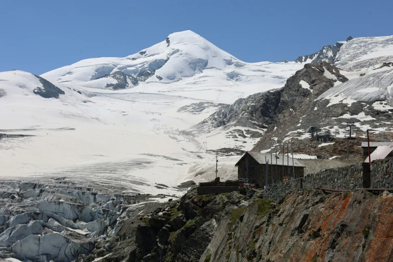 a large mountain with an orange train coming down it