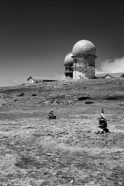 a small old looking building on a hill