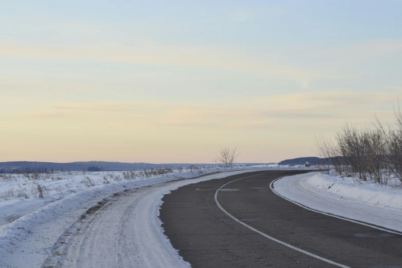 a curve of a road is shown during the day