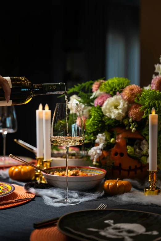 a table topped with plates, glasses of wine and candles