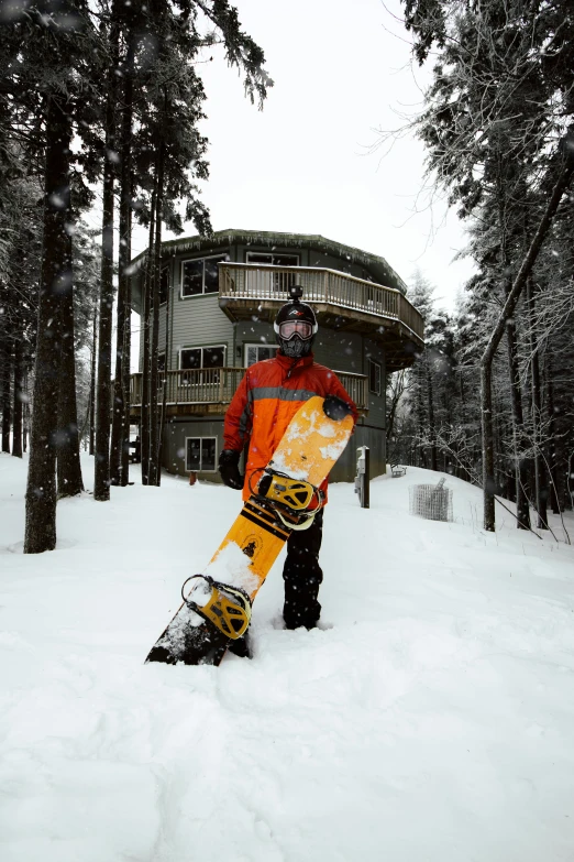 a snowboarder is holding his snowboard in the snow