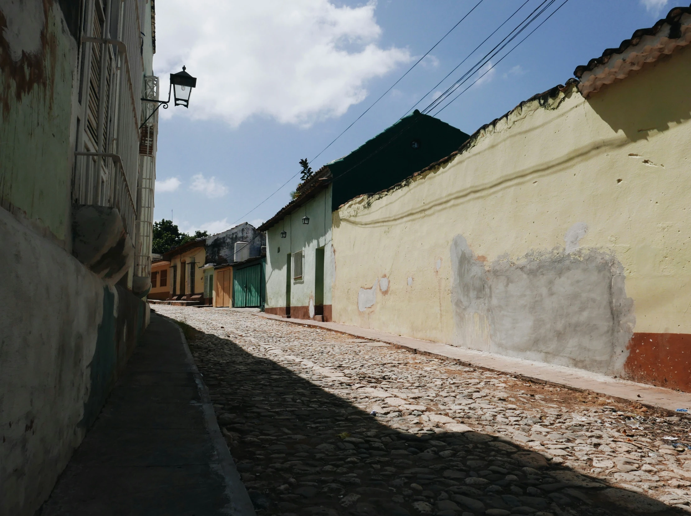 the shadows of buildings line a street