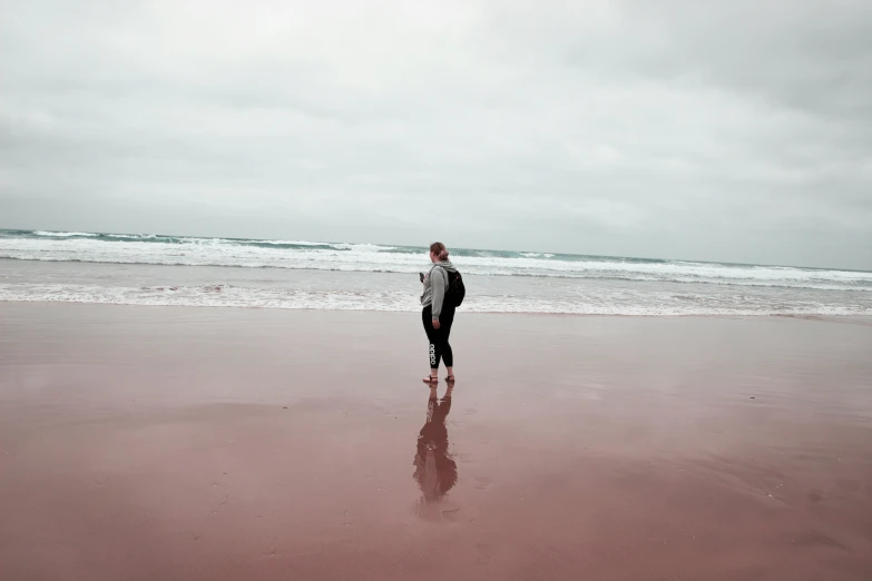 woman standing in the water on a beach