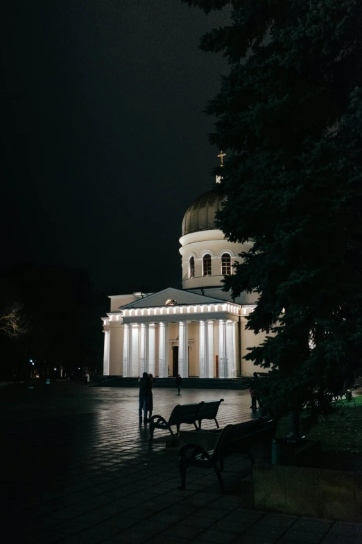 a building lit up by lights with the night sky