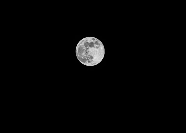 a dark sky with a small amount of moon in the distance