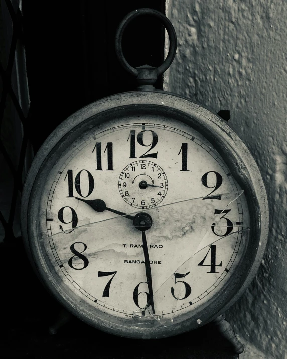 an old timer clock is next to a wall