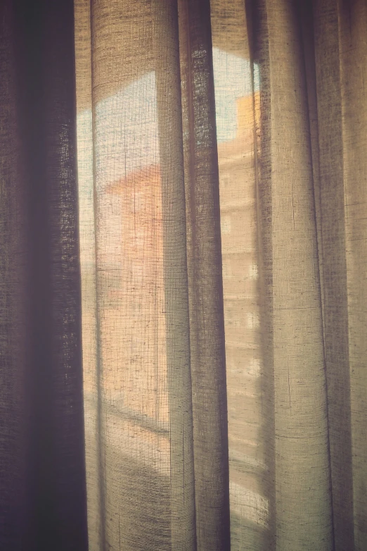 curtained windows with curtains open and sunlight in the middle