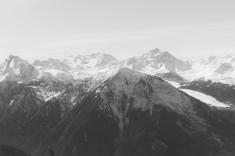 a mountain with snow covered mountains in the distance