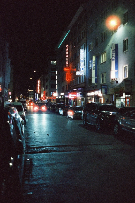 a busy city street at night with bright lights