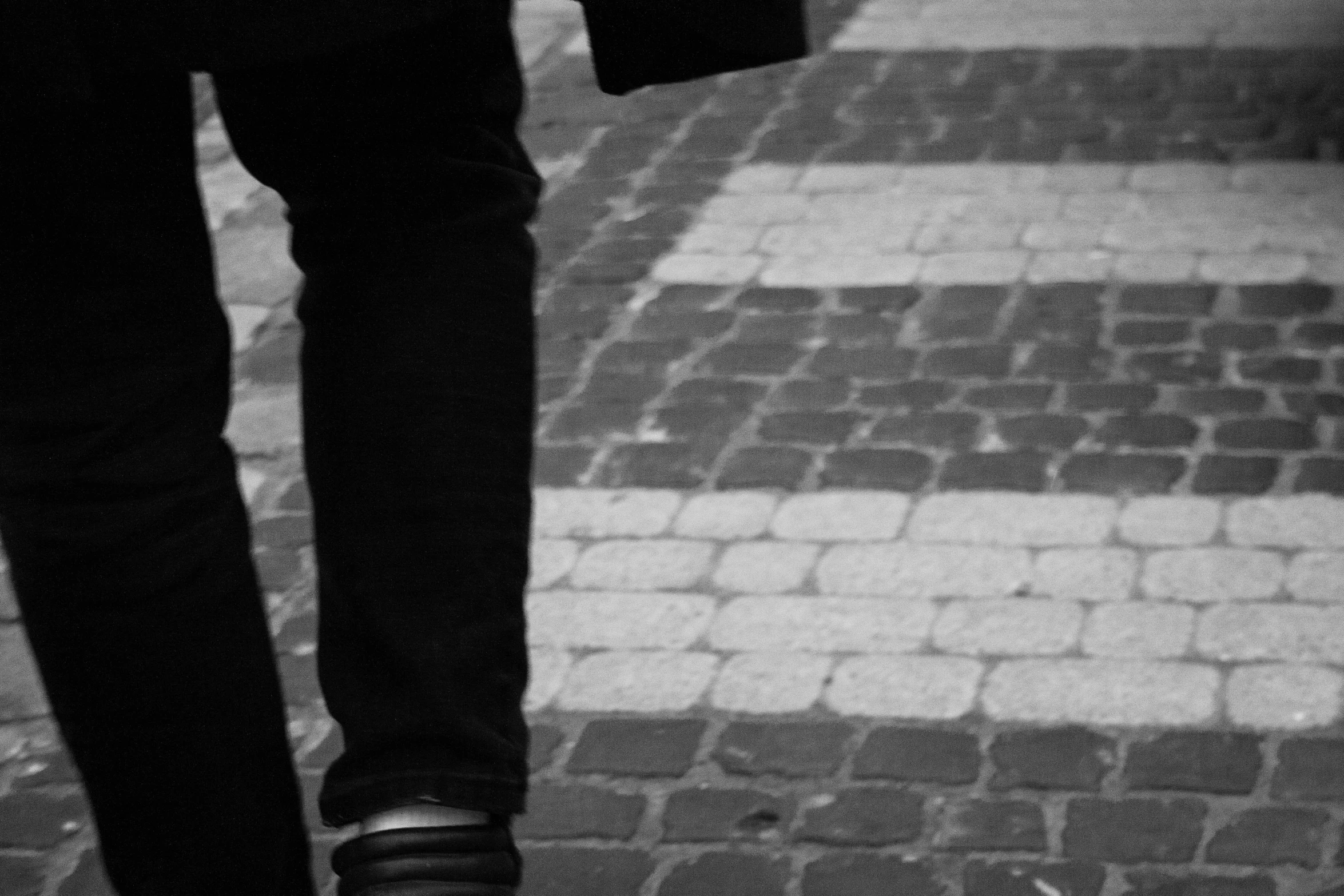 a person standing on a tile floor while carrying an umbrella