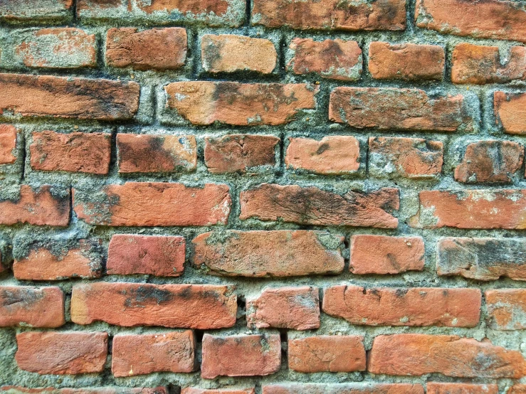 an old brick wall made of red and orange bricks