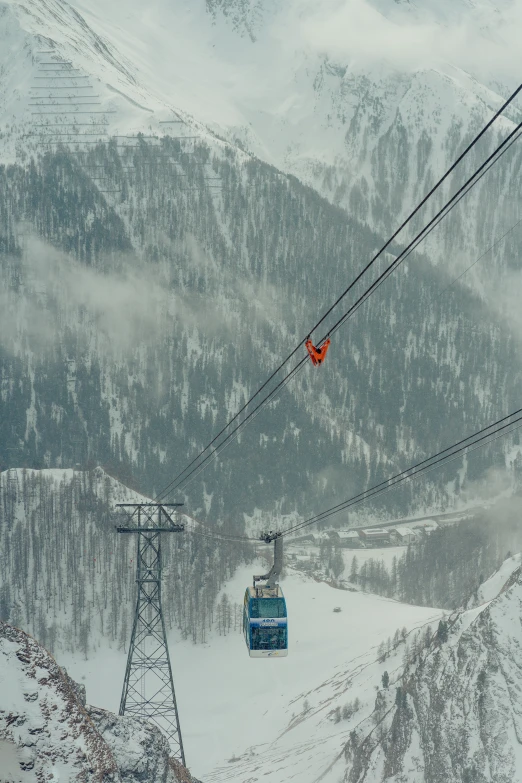 two people ride the ski lift during a snow storm