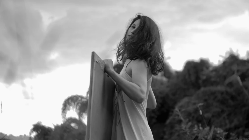 a girl leaning on the fence looking up at her