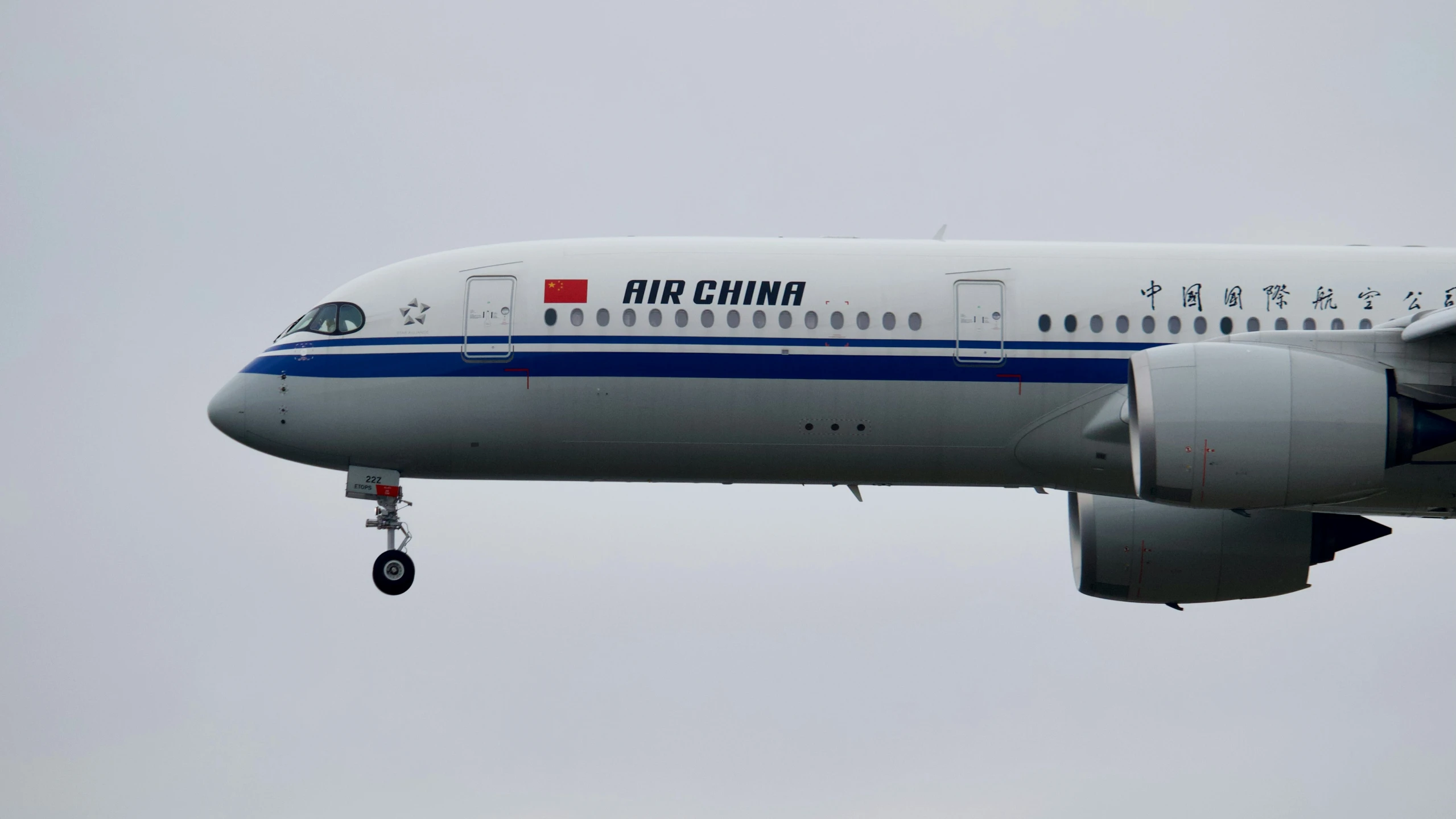 a large commercial jetliner flying through a cloudy sky