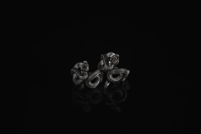 a pair of rings that are on a black table