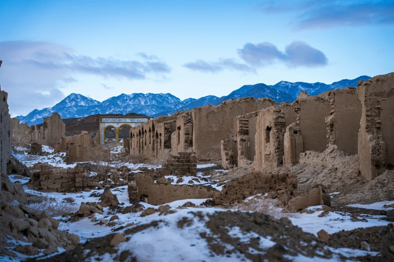 an ancient city near the mountains with snow