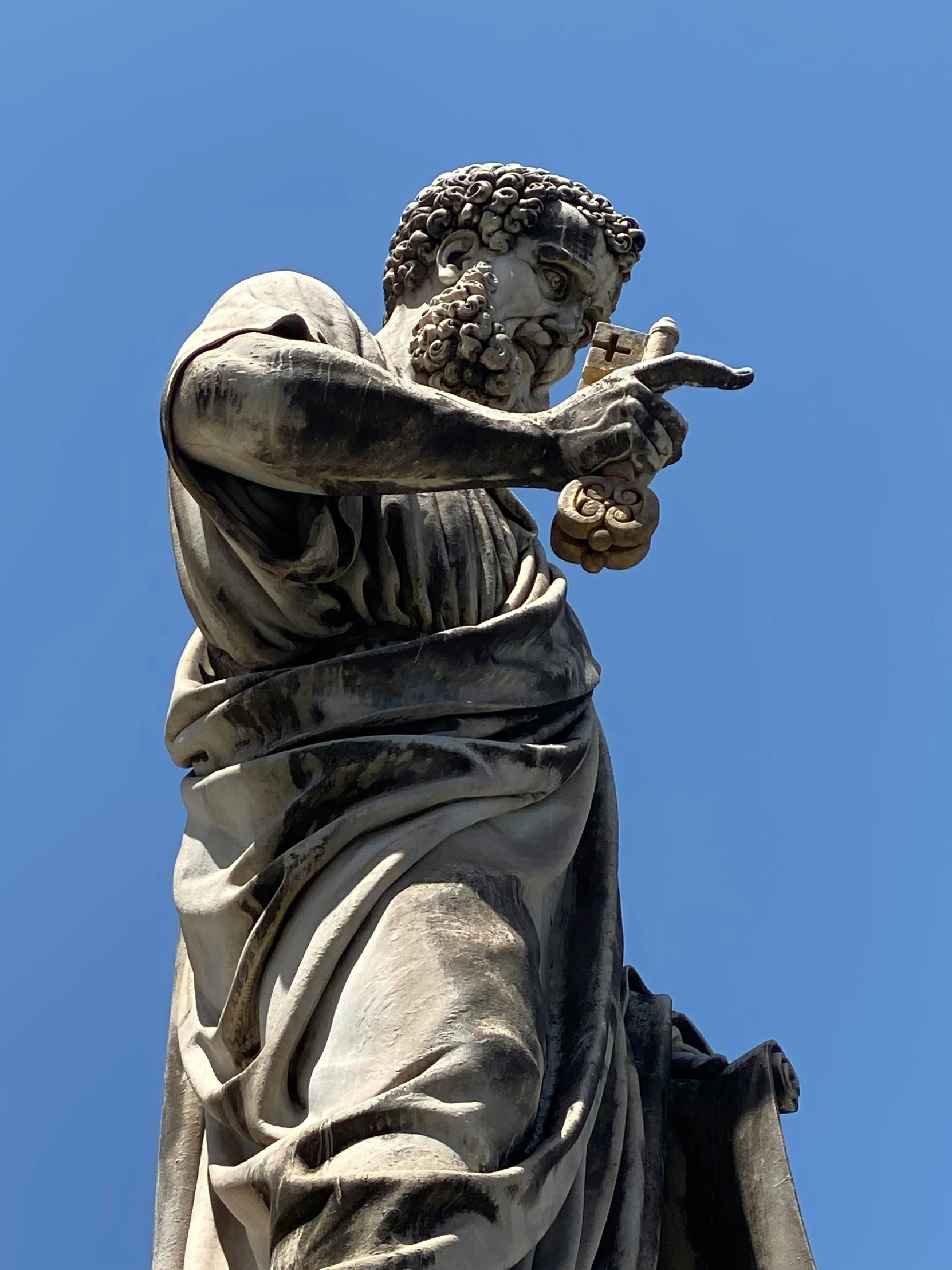 a statue that is holding a pipe and wearing a long gown