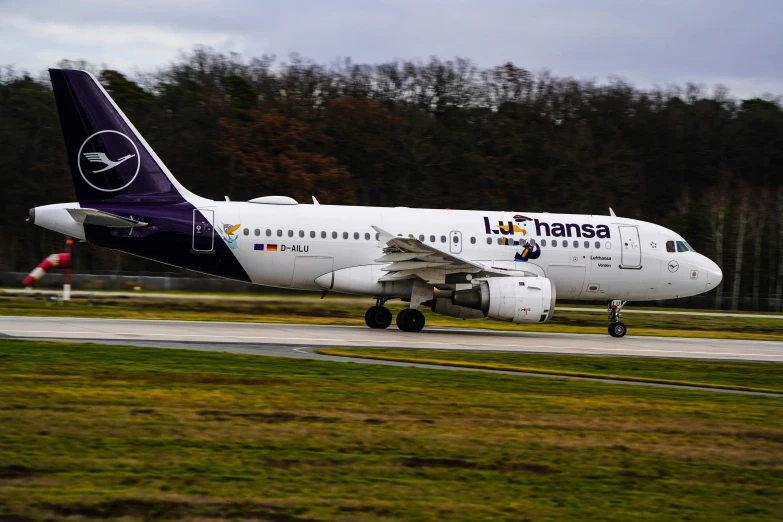 a large airplane landing on an airport runway