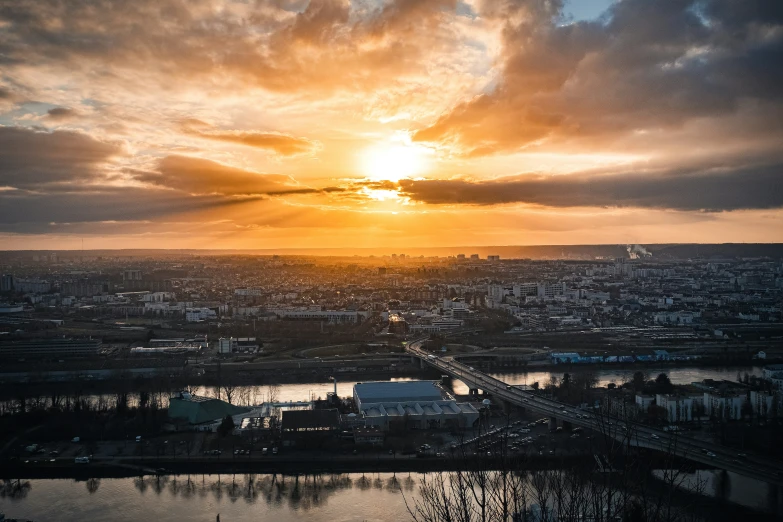 the sun is setting over a large city