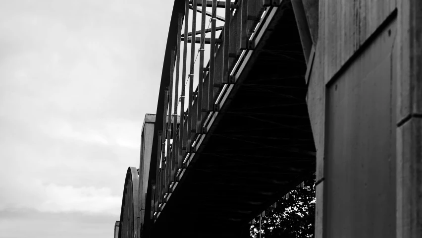 a black and white pograph of a bridge over water