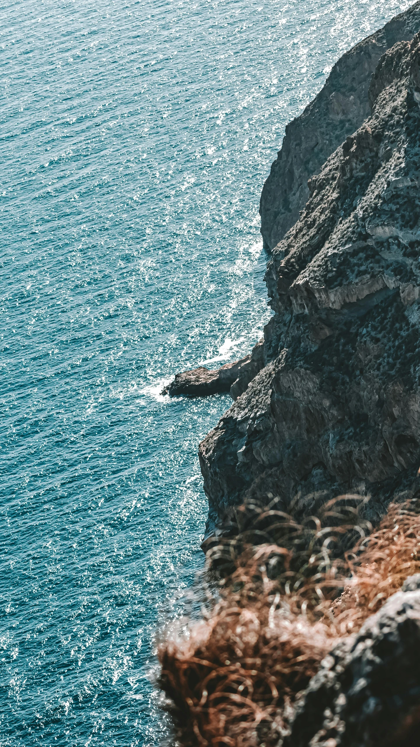 the cliff edge is above the ocean water