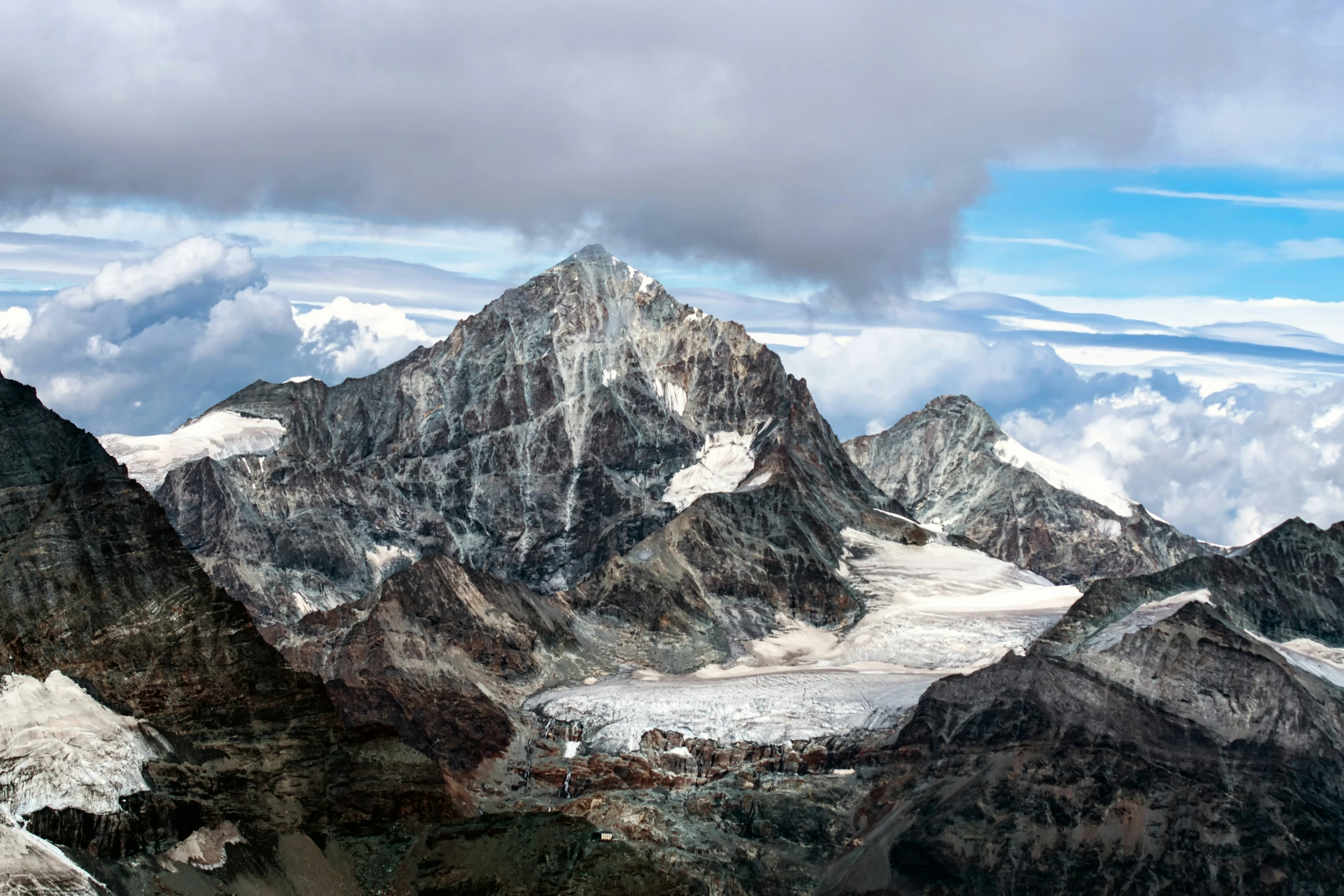 an aerial view of a mountain range taken in the sky