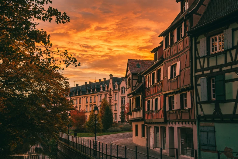 several different colored buildings are in the sun set