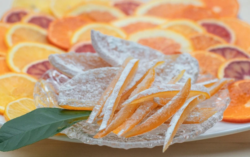 a plate topped with sugar covered oranges and slices