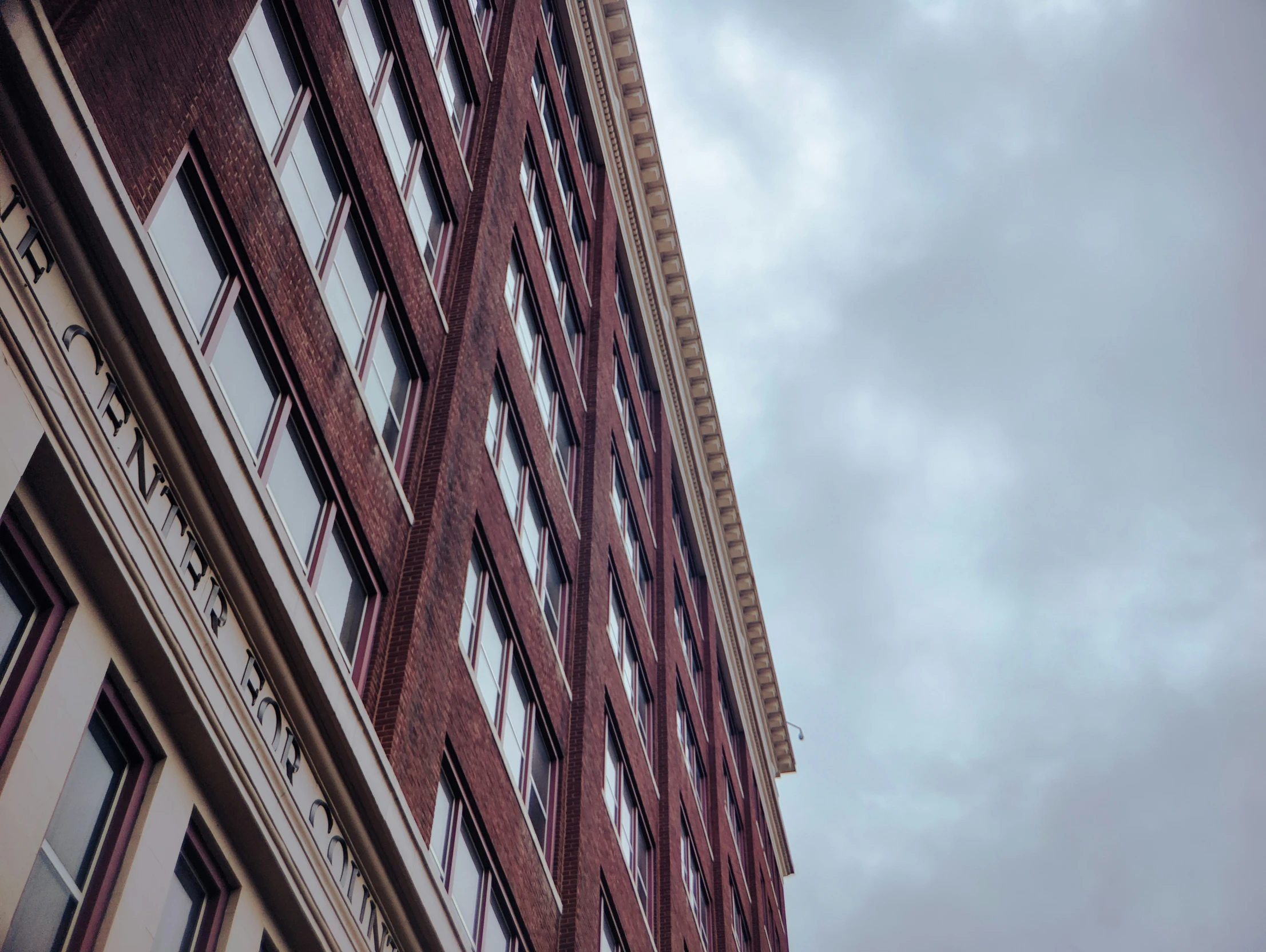 a building has windows and a clock that reads 14 11