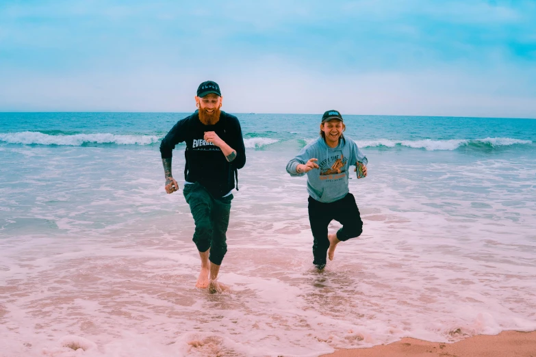 two people jogging in the water at the beach