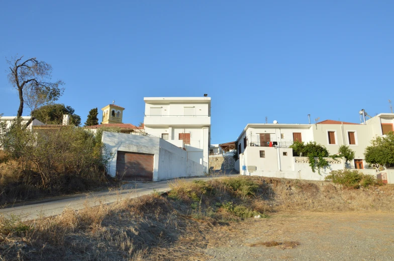 some buildings that are sitting out on the side of the road