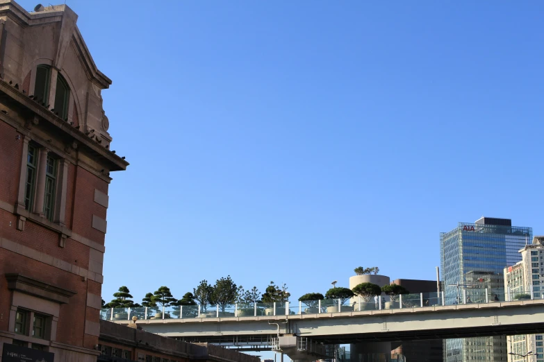 a bridge going over a body of water next to a brick building