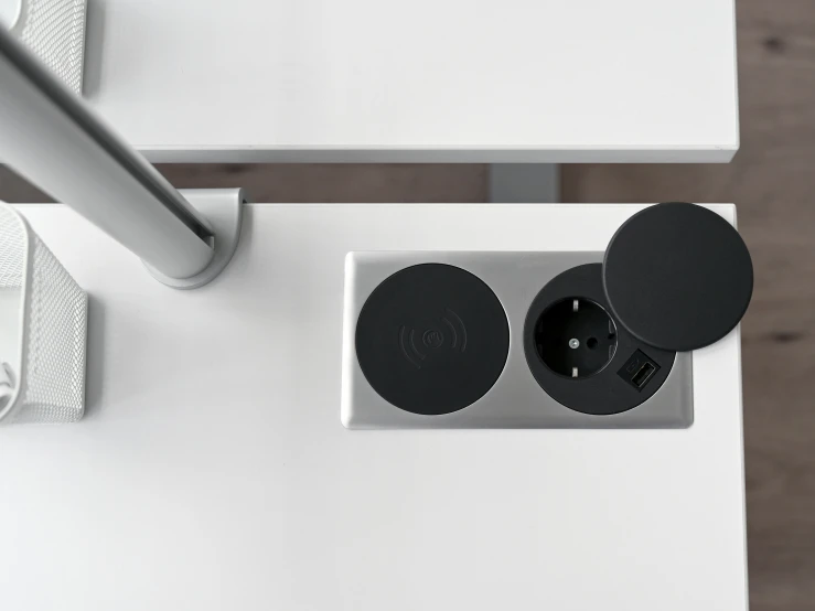 two speakers on top of a white table