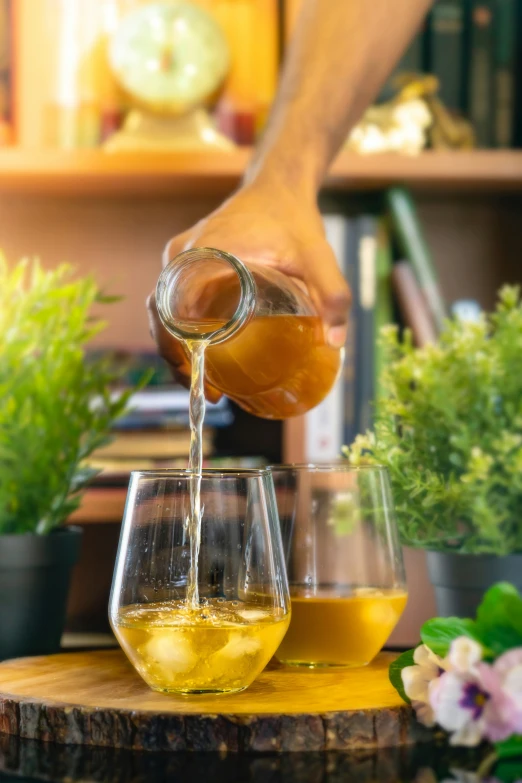 a person pouring a liquid into a wine glass