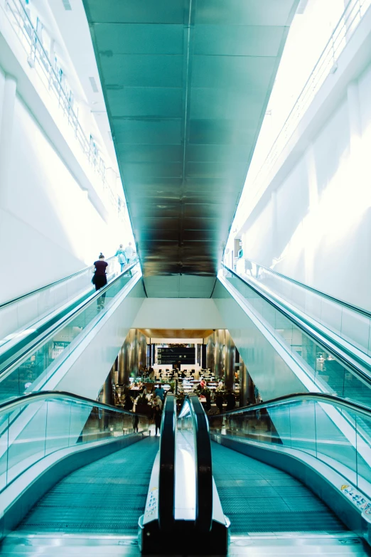 a person riding an escalator in an airport