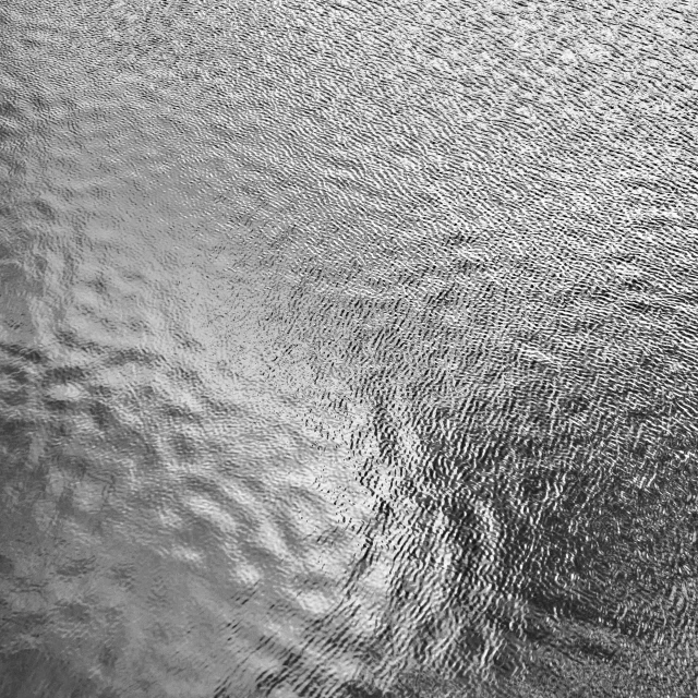 a black and white image of a water surface
