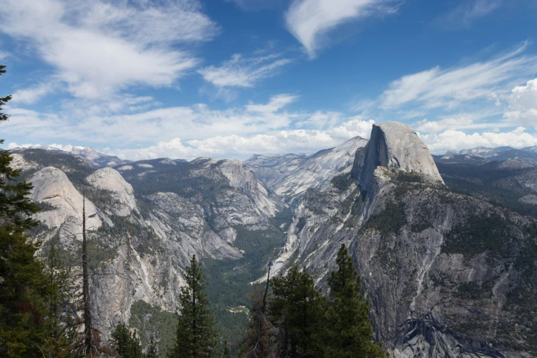 there are many mountains with tall trees on each side