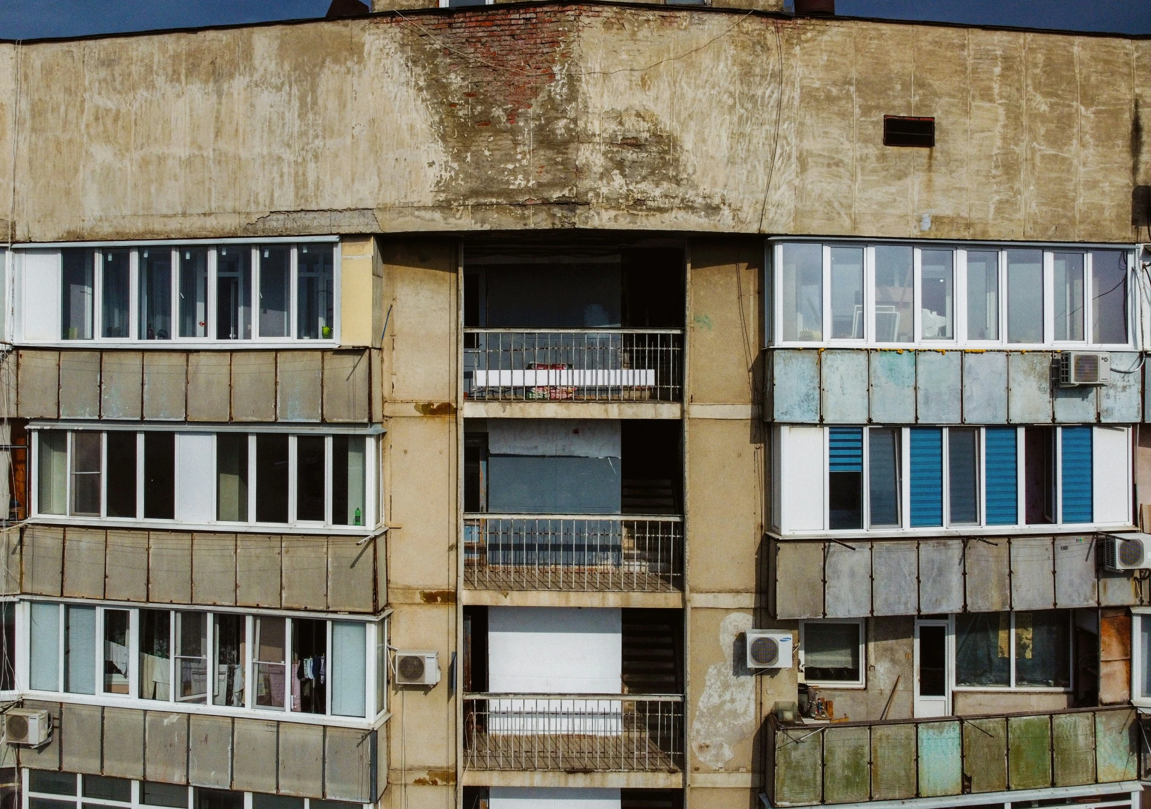 an old apartment building with several balconies and a clock tower