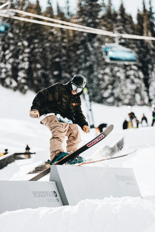 a man on a snowboard going over some stairs