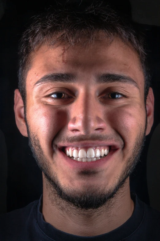 a close up of a man smiling with very light colored hair