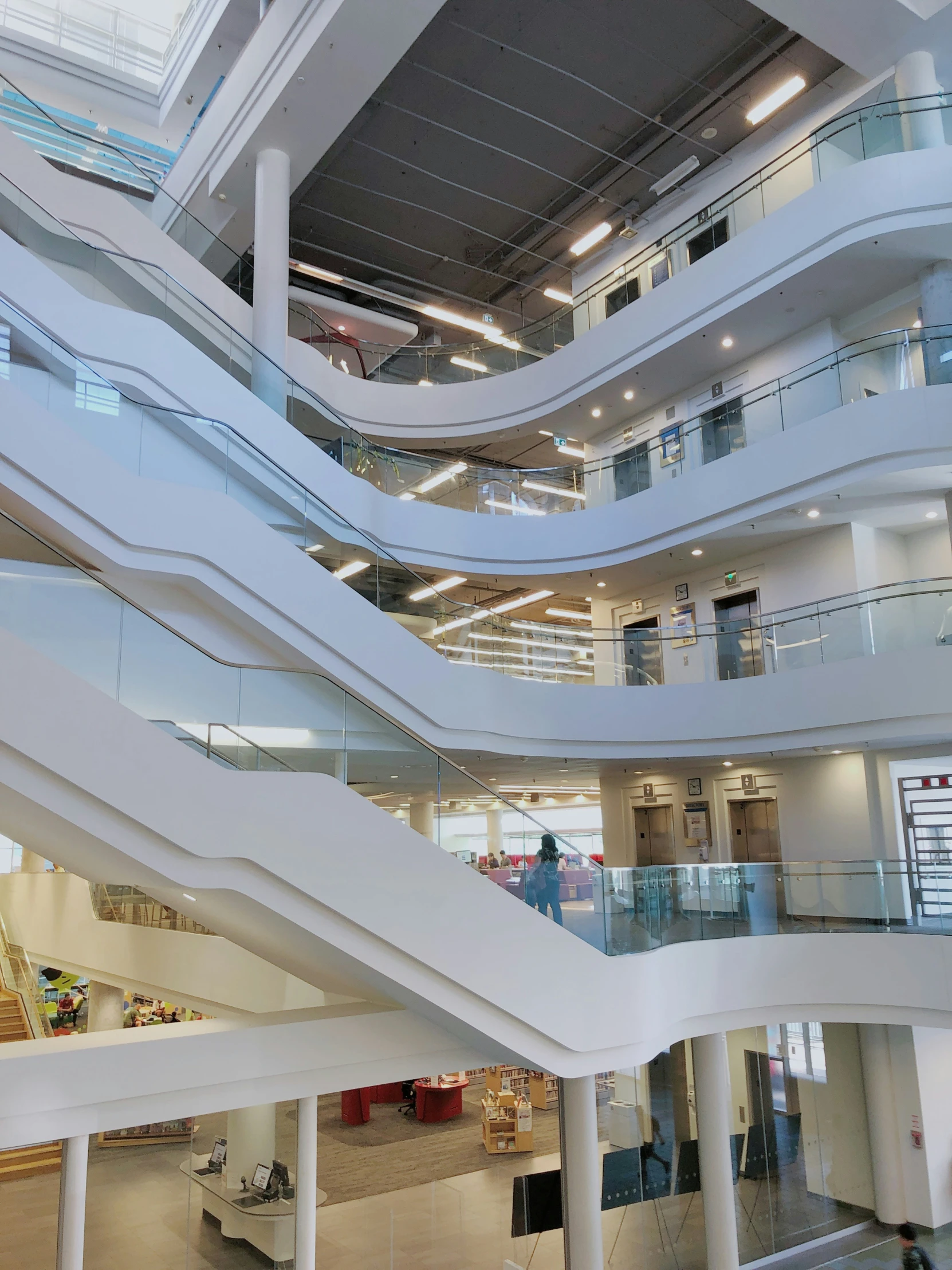 an indoor area with multiple white steps and escalators