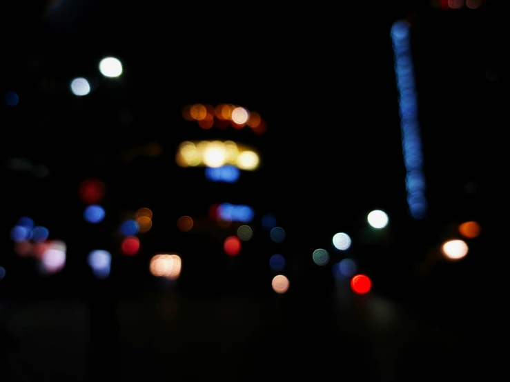 a blurry po shows the lights of city buildings