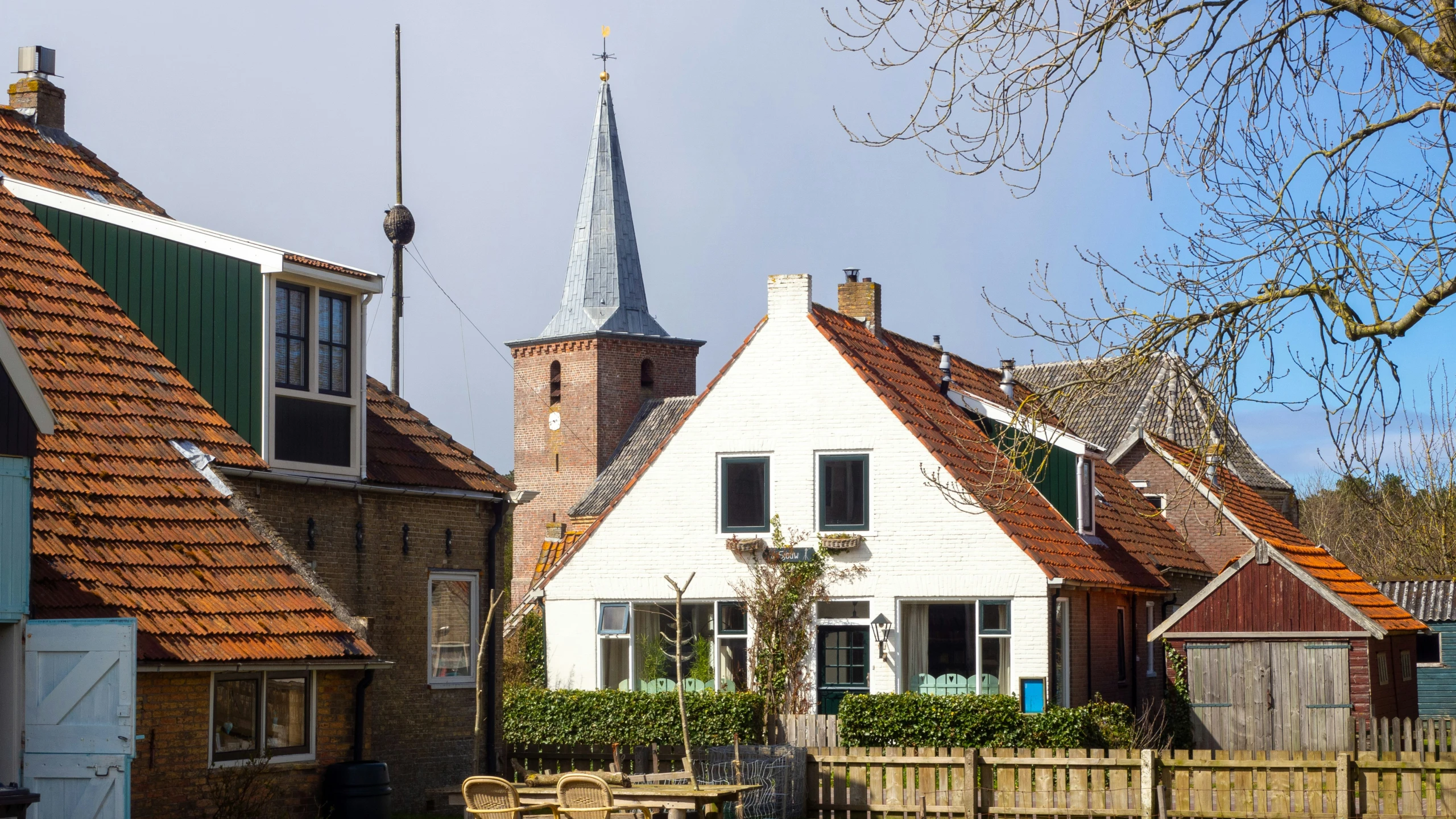 a row of houses with an old church steeple