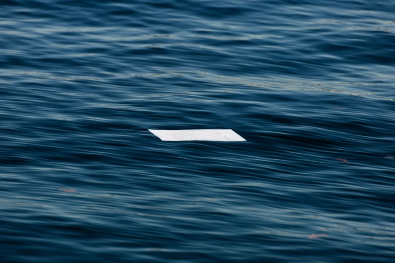 a paper floating in the middle of the ocean