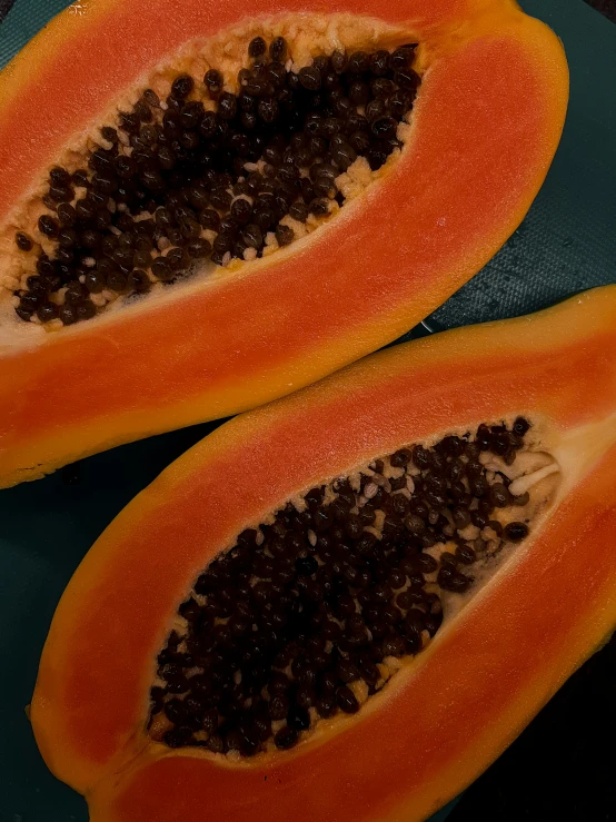 an orange papaya cut in half and cut into pieces