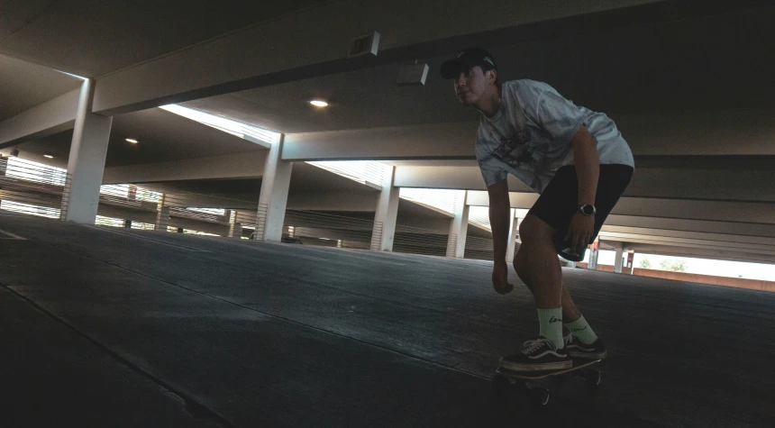 a man on a skate board in the middle of a road